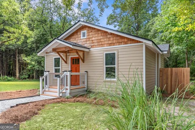 a view of backyard of house with green space