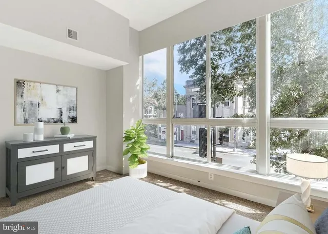 a living room with furniture and a floor to ceiling window