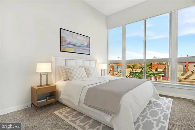 a bedroom with a large bed and a large window