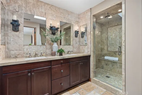 a bathroom with a shower sink and mirror