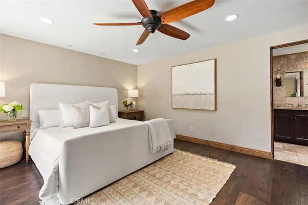 a bedroom with a bed and a painting on the wall