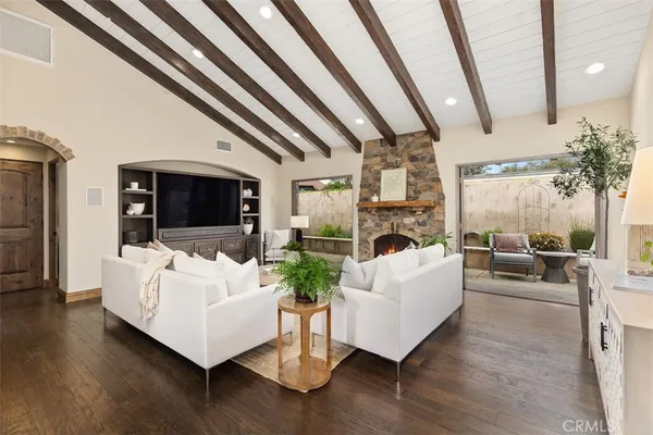 a living room with furniture fireplace and flat screen tv