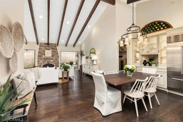 a dining room with furniture wooden floor a chandelier