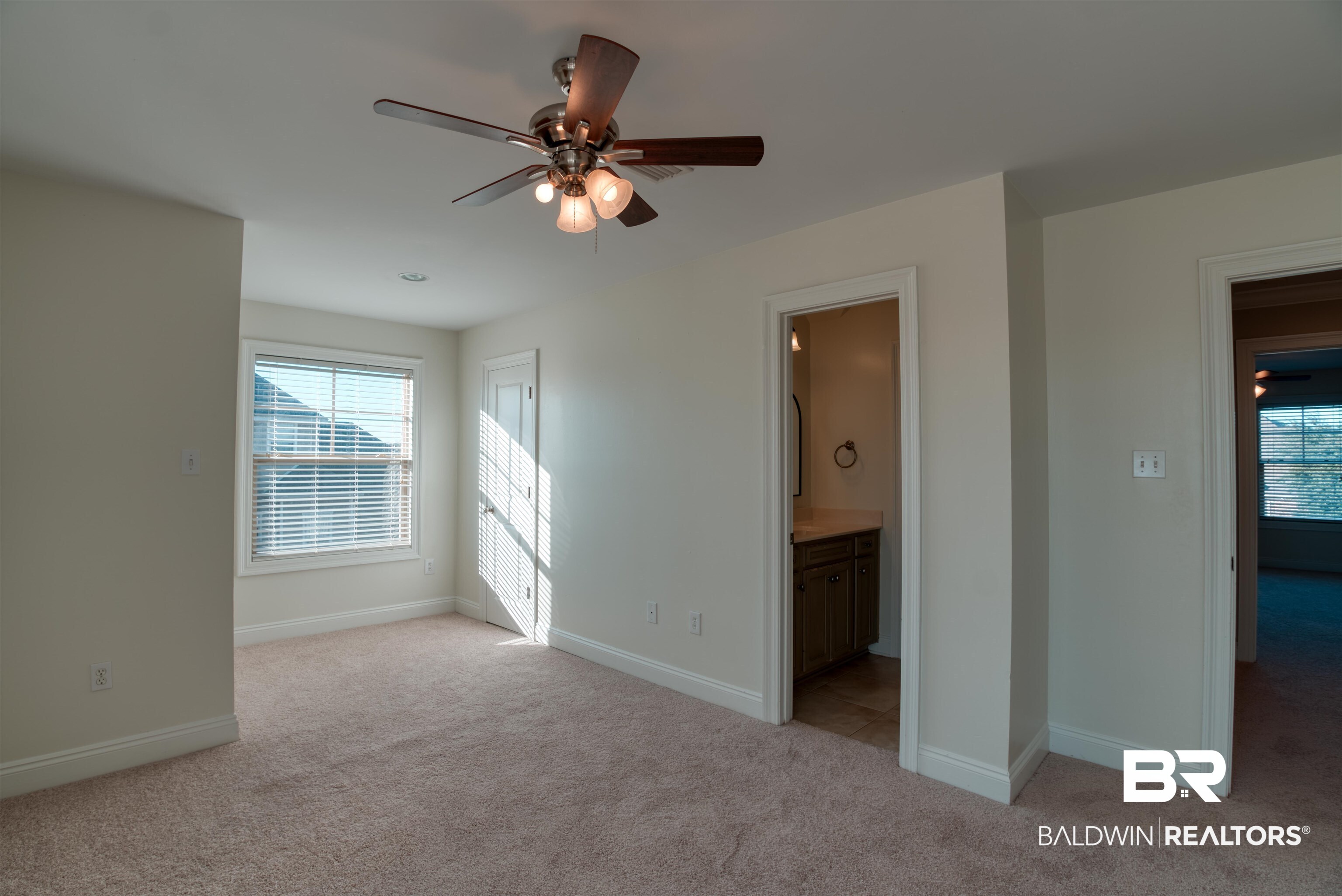 24561 Austin Road Daphne, AL 36526 - Photo 32 of 57 Unfurnished bedroom featuring ensuite bathroom, ceiling fan, and light colored carpet