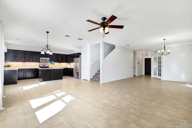 a view of a kitchen with a sink and a ceiling fan