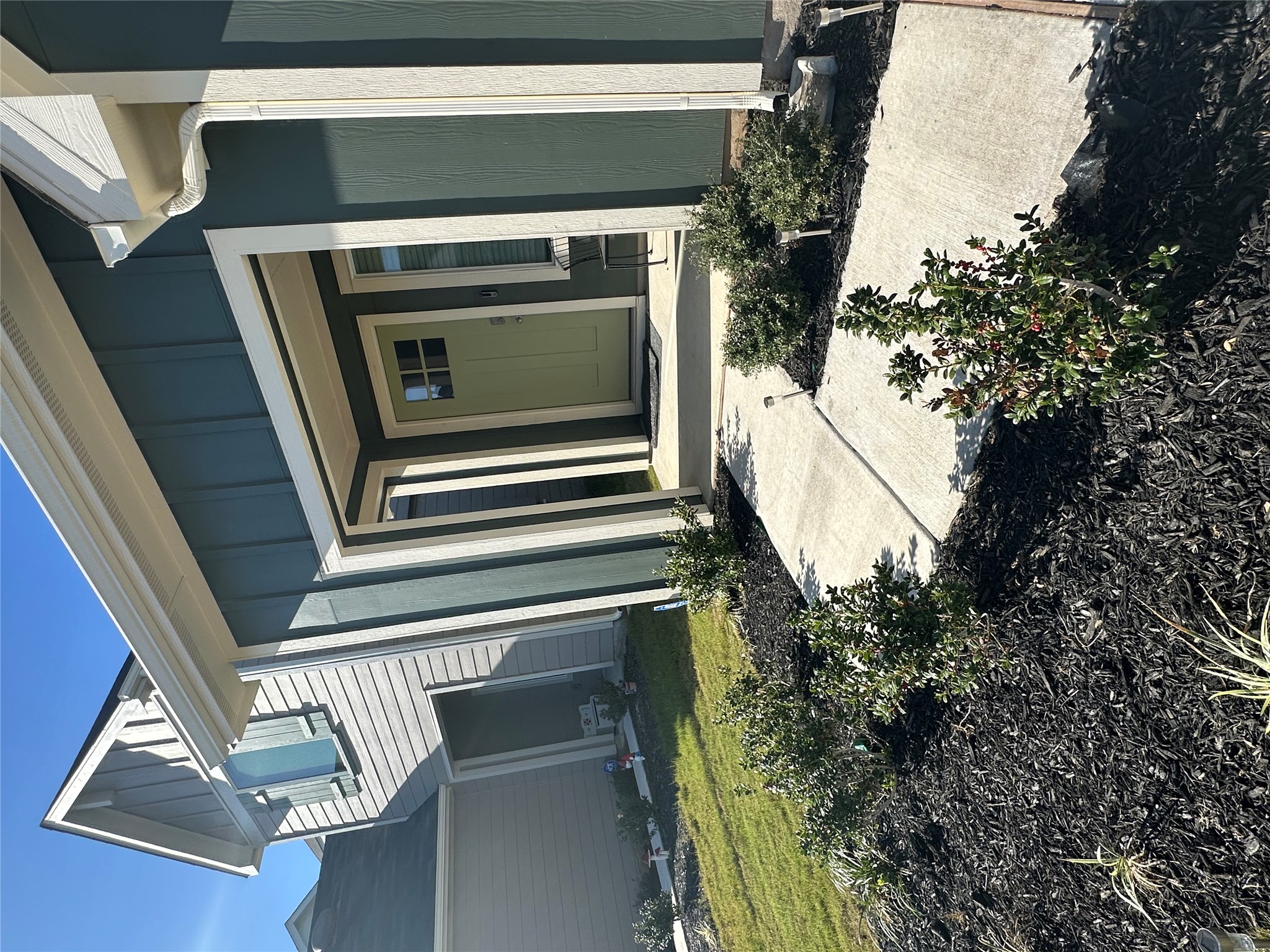 519 Sandringham Loop Kyle, TX 78640 - Photo 25 of 26 Doorway to property featuring board and batten siding, covered porch, and a yard