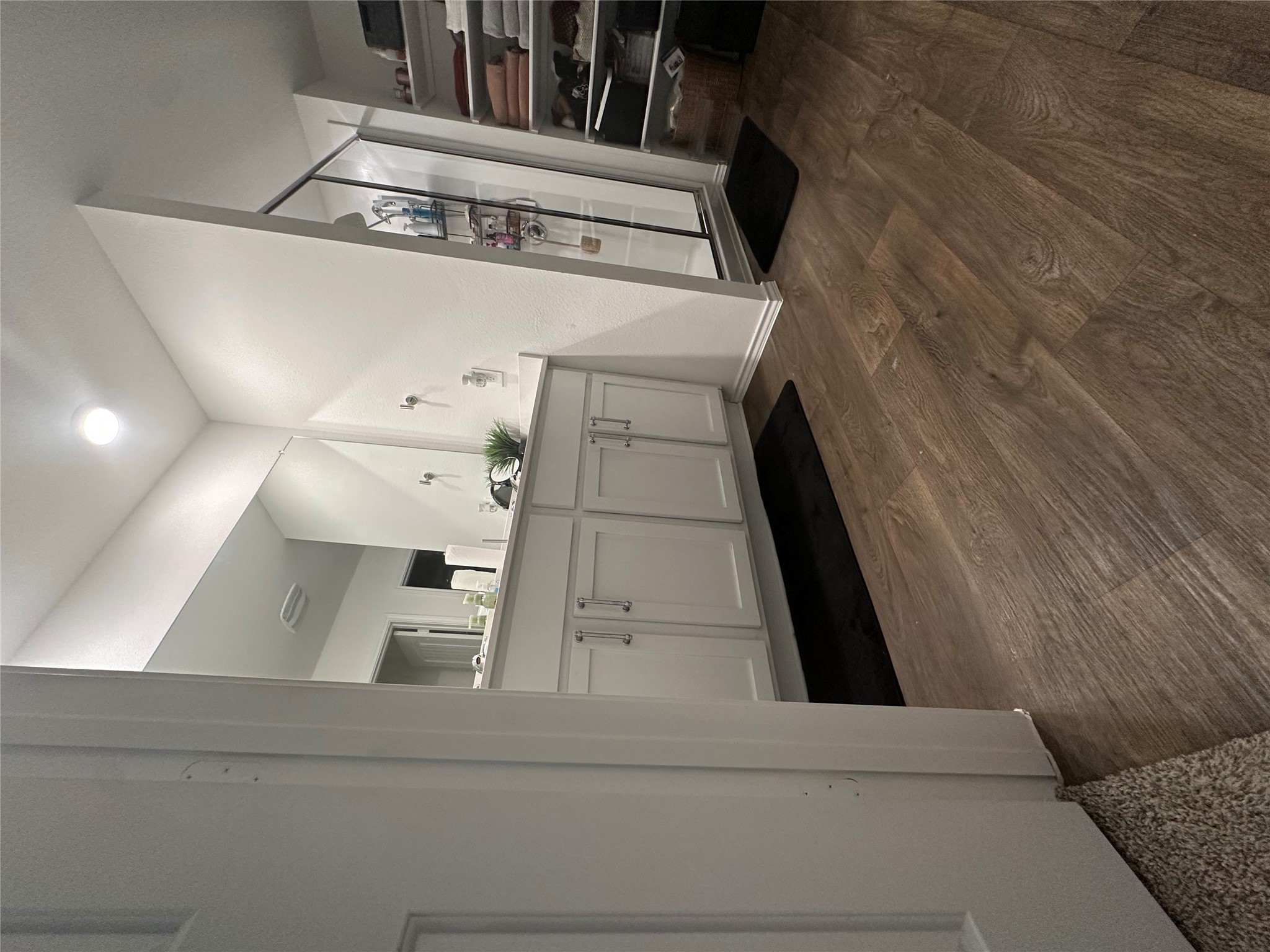 519 Sandringham Loop Kyle, TX 78640 - Photo 3 of 26 Full bath featuring double vanity, a stall shower, and dark wood-style flooring