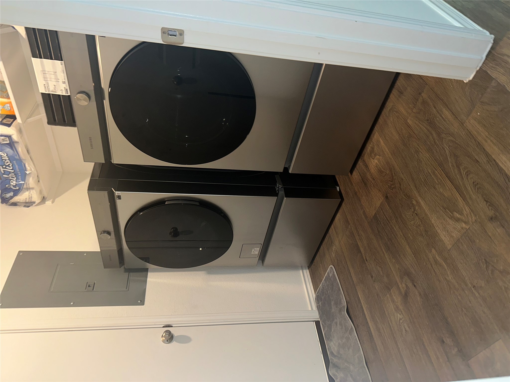 519 Sandringham Loop Kyle, TX 78640 - Photo 10 of 26 Washroom with dark wood-style flooring, electric panel, and washing machine and clothes dryer
