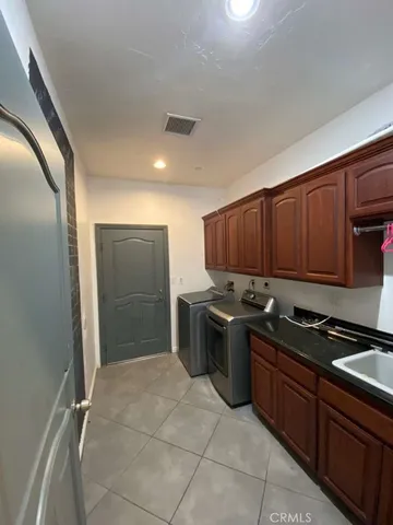 a view of a room with a ceiling fan and window