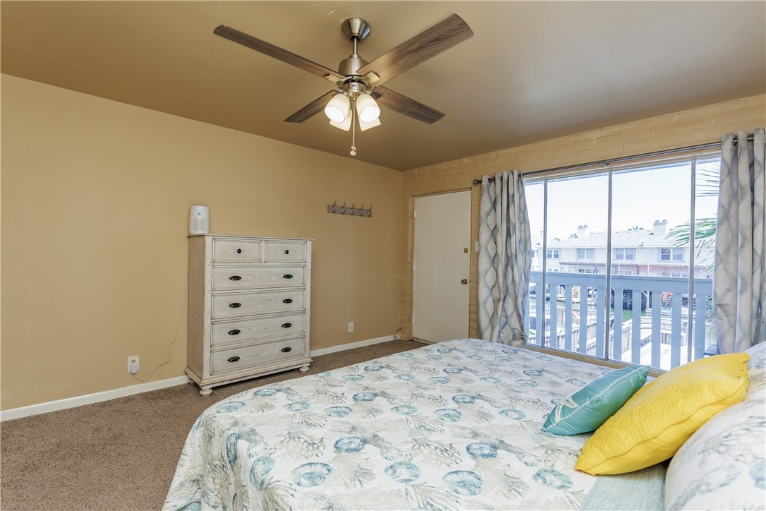 15432 Salt Cay Court, Unit 101 Corpus Christi, TX 78418 - Photo 15 of 37 a bedroom with a large bed and a window