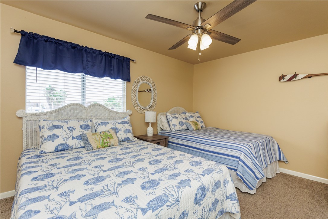 15432 Salt Cay Court, Unit 101 Corpus Christi, TX 78418 - Photo 16 of 37 a bedroom with a bed and a window