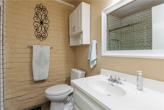 a bathroom with a sink toilet and a mirror