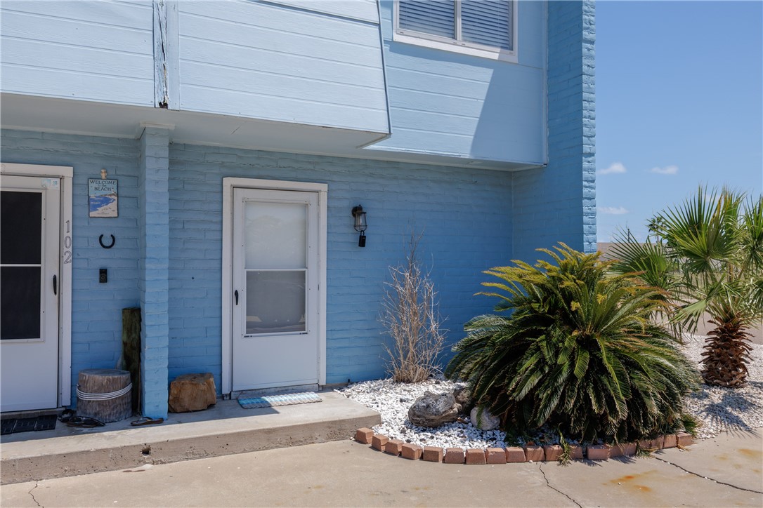 15432 Salt Cay Court, Unit 101 Corpus Christi, TX 78418 - Photo 2 of 37 a potted plant sitting in front of a building