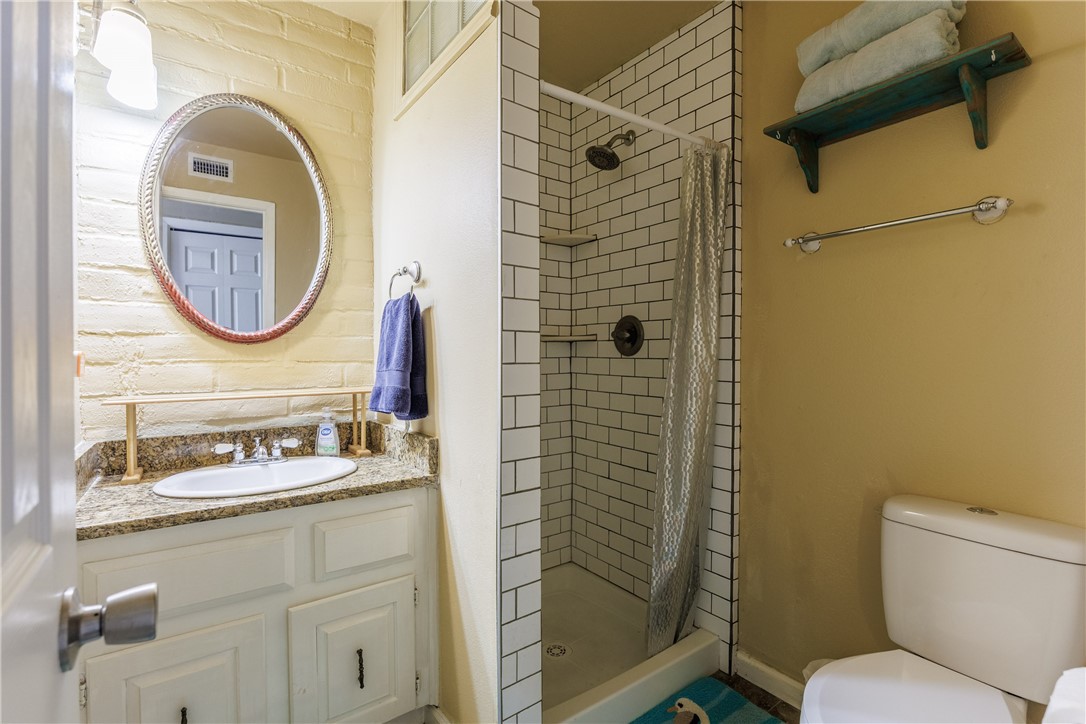 15432 Salt Cay Court, Unit 101 Corpus Christi, TX 78418 - Photo 21 of 37 a bathroom with a sink and a mirror