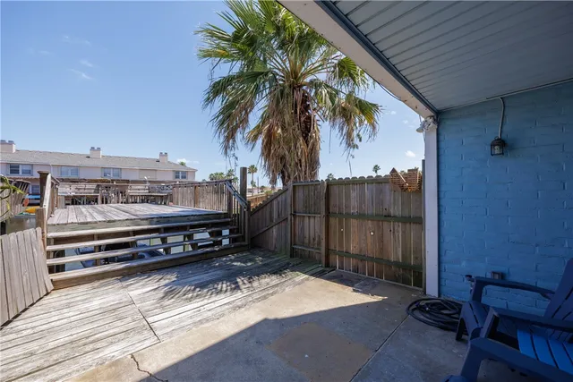 a view of a patio with a table and chairs