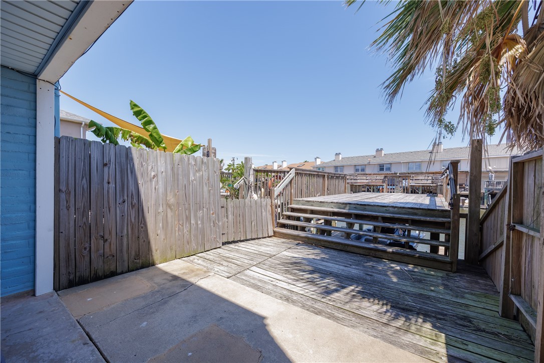 15432 Salt Cay Court, Unit 101 Corpus Christi, TX 78418 - Photo 26 of 37 a roof deck with a table and a barbeque
