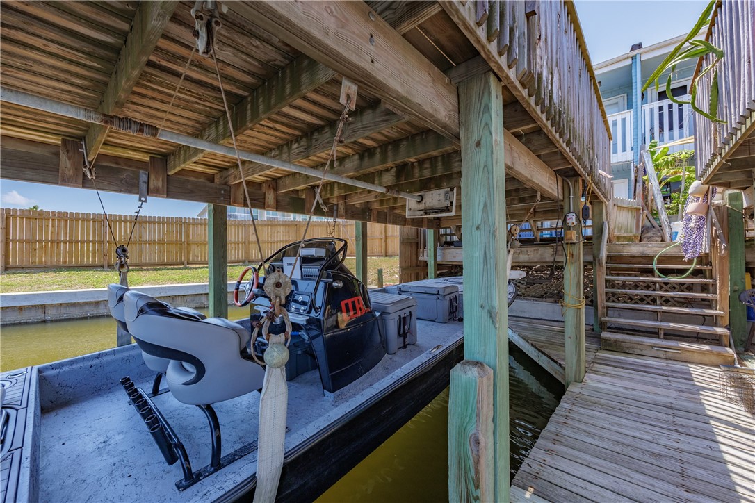 15432 Salt Cay Court, Unit 101 Corpus Christi, TX 78418 - Photo 32 of 37 a view of a chairs and table in a patio with wooden fence