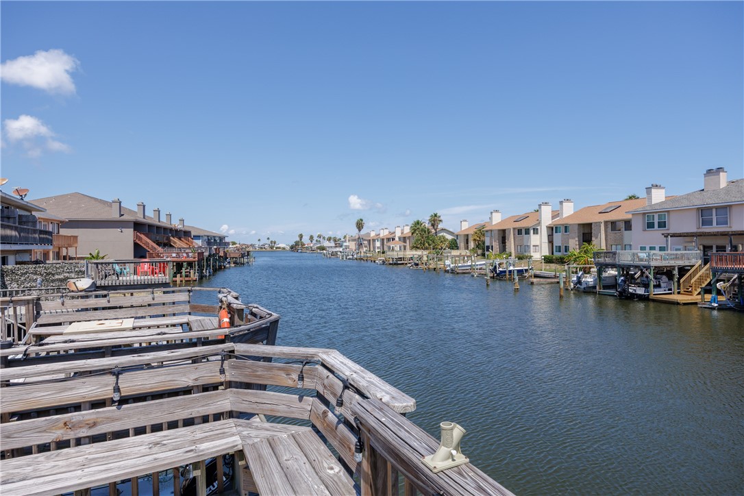 15432 Salt Cay Court, Unit 101 Corpus Christi, TX 78418 - Photo 35 of 37 a view of a lake with a city skyline in the background