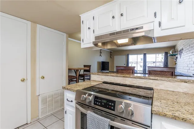 a kitchen with stainless steel appliances granite countertop a stove a refrigerator and a granite counter tops