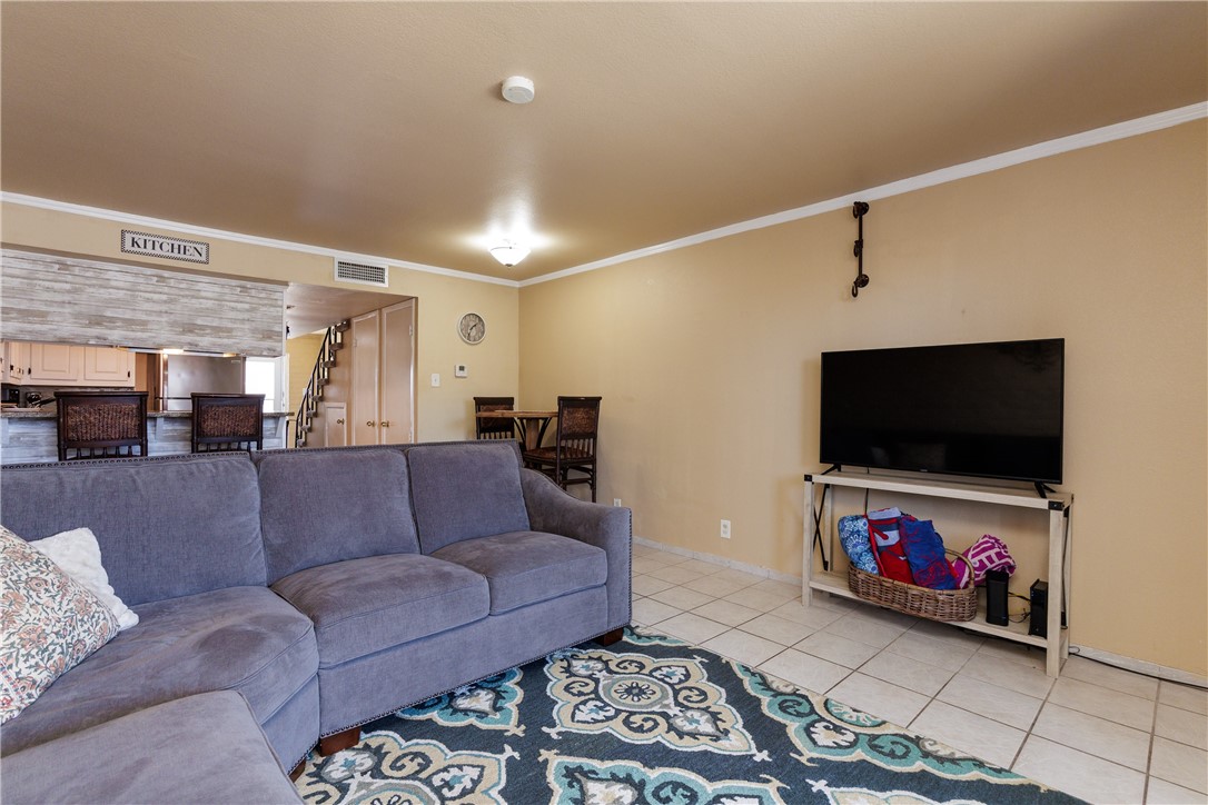 15432 Salt Cay Court, Unit 101 Corpus Christi, TX 78418 - Photo 10 of 37 a living room with furniture and a flat screen tv