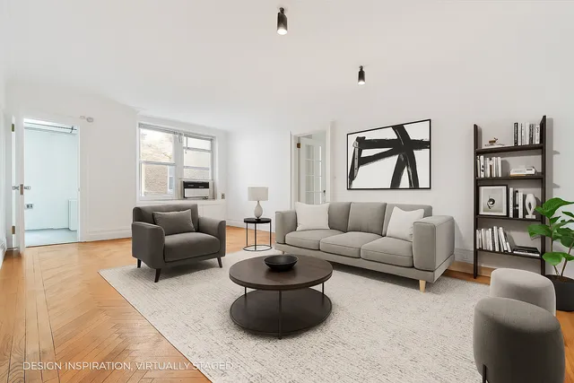 a view of empty room with cabinet and wooden floor