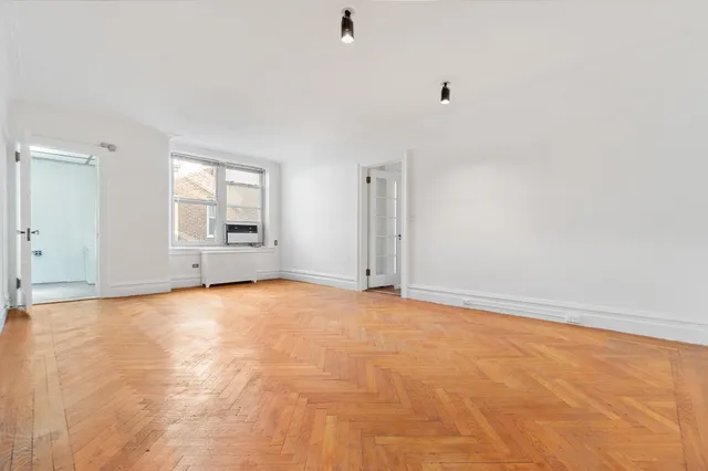 a living room with furniture and a book shelf