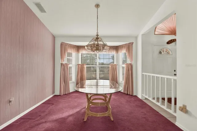 a view of kitchen with furniture and refrigerator