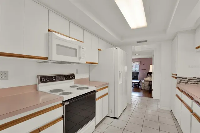 a kitchen with a stove and a refrigerator