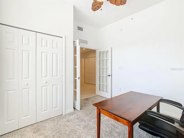 a view of a hallway with wooden floor and cabinet