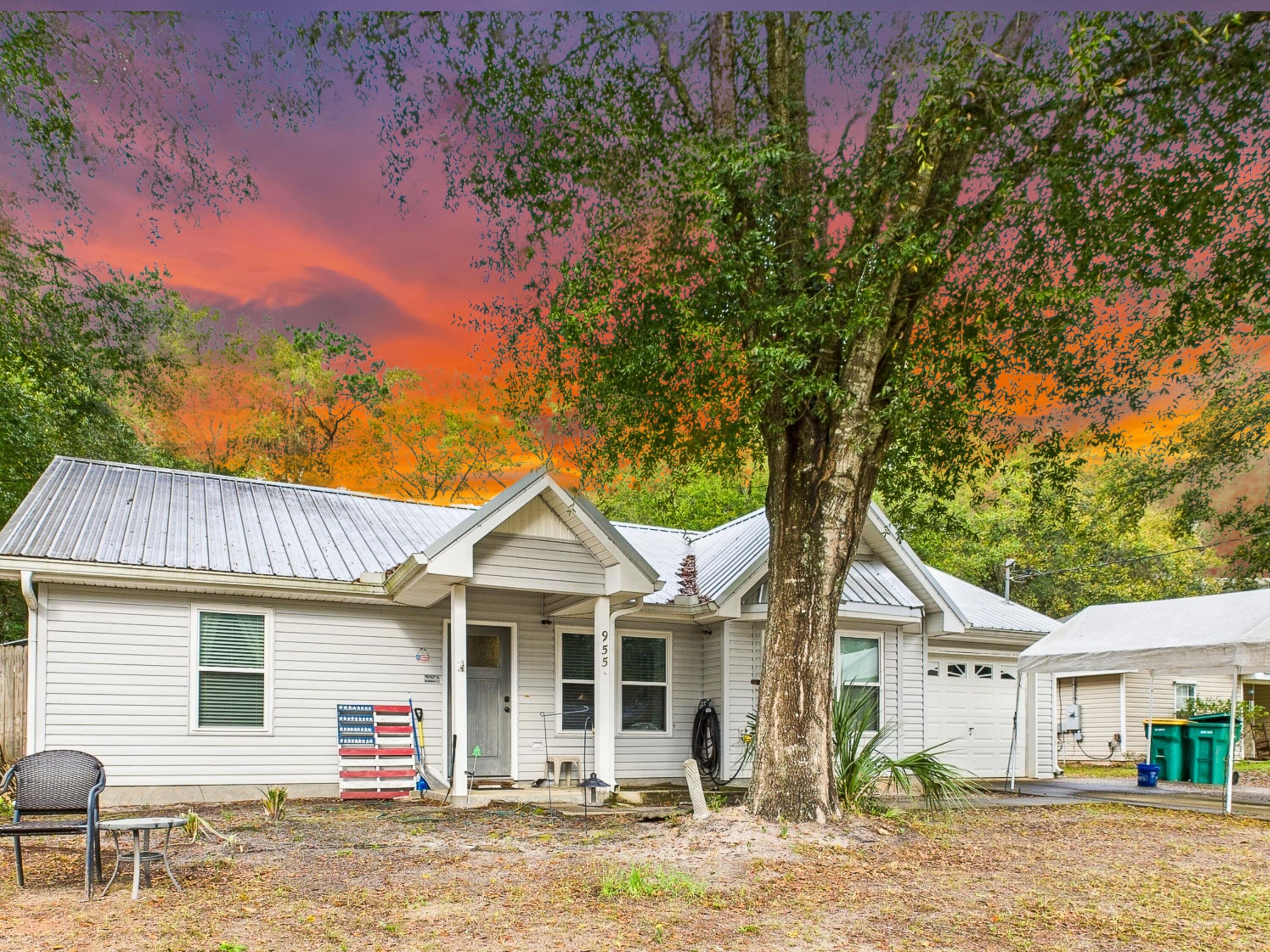 a front view of a house with a garden and yard