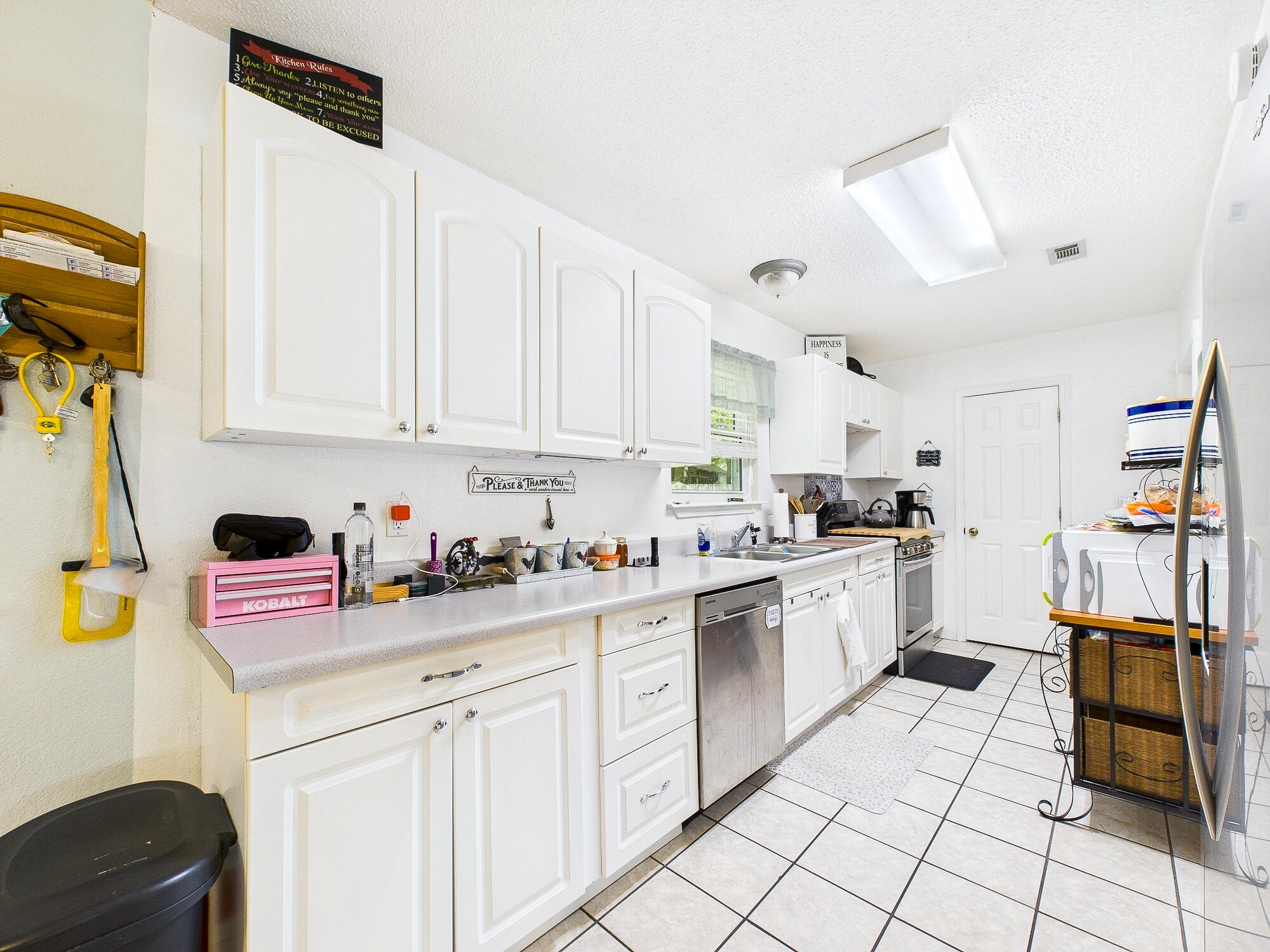 955 Valley Road Crestview, FL 32539 - Photo 12 of 29 a kitchen with white cabinets and appliances