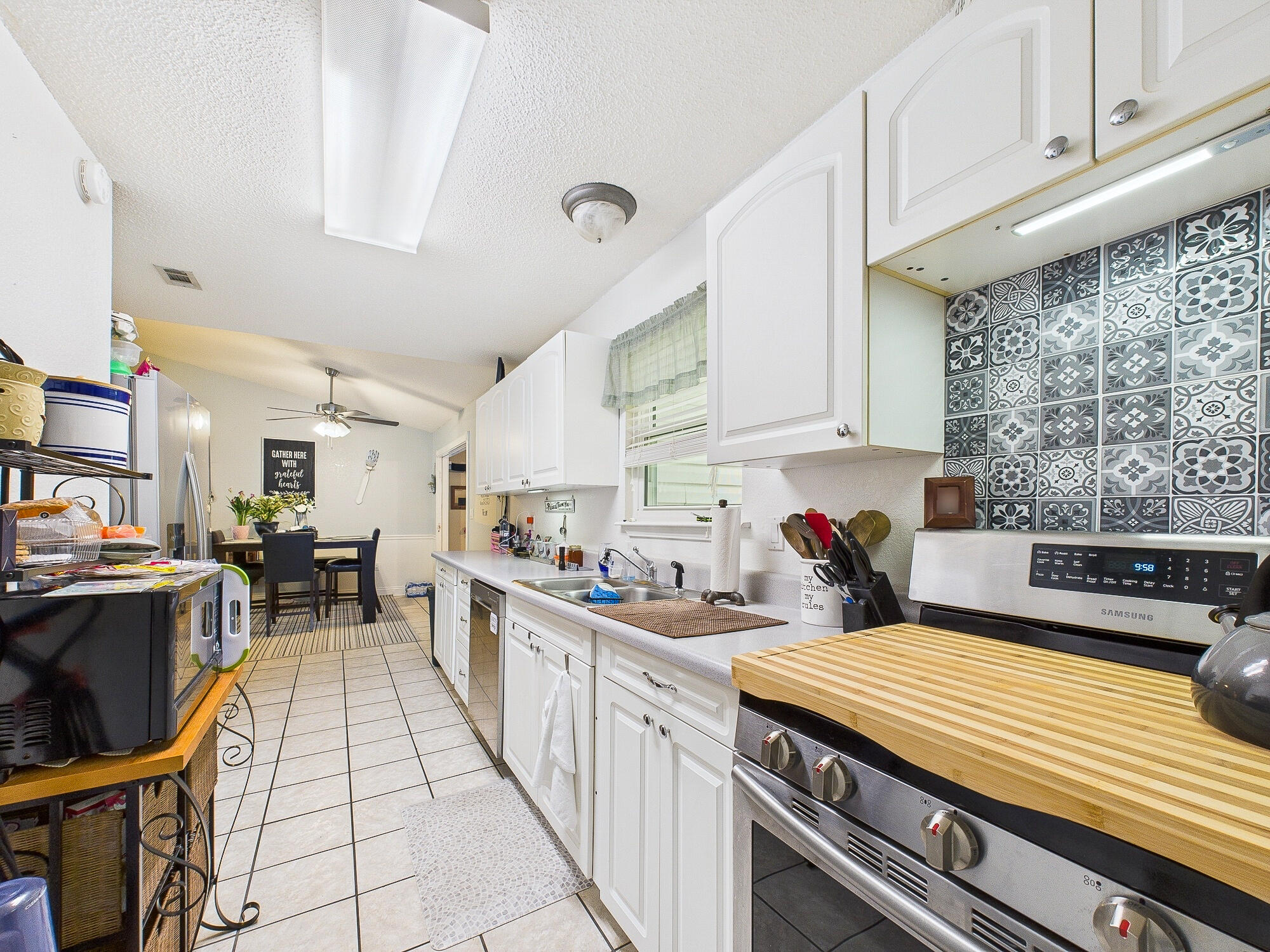 955 Valley Road Crestview, FL 32539 - Photo 13 of 29 a kitchen with a stove and white cabinets