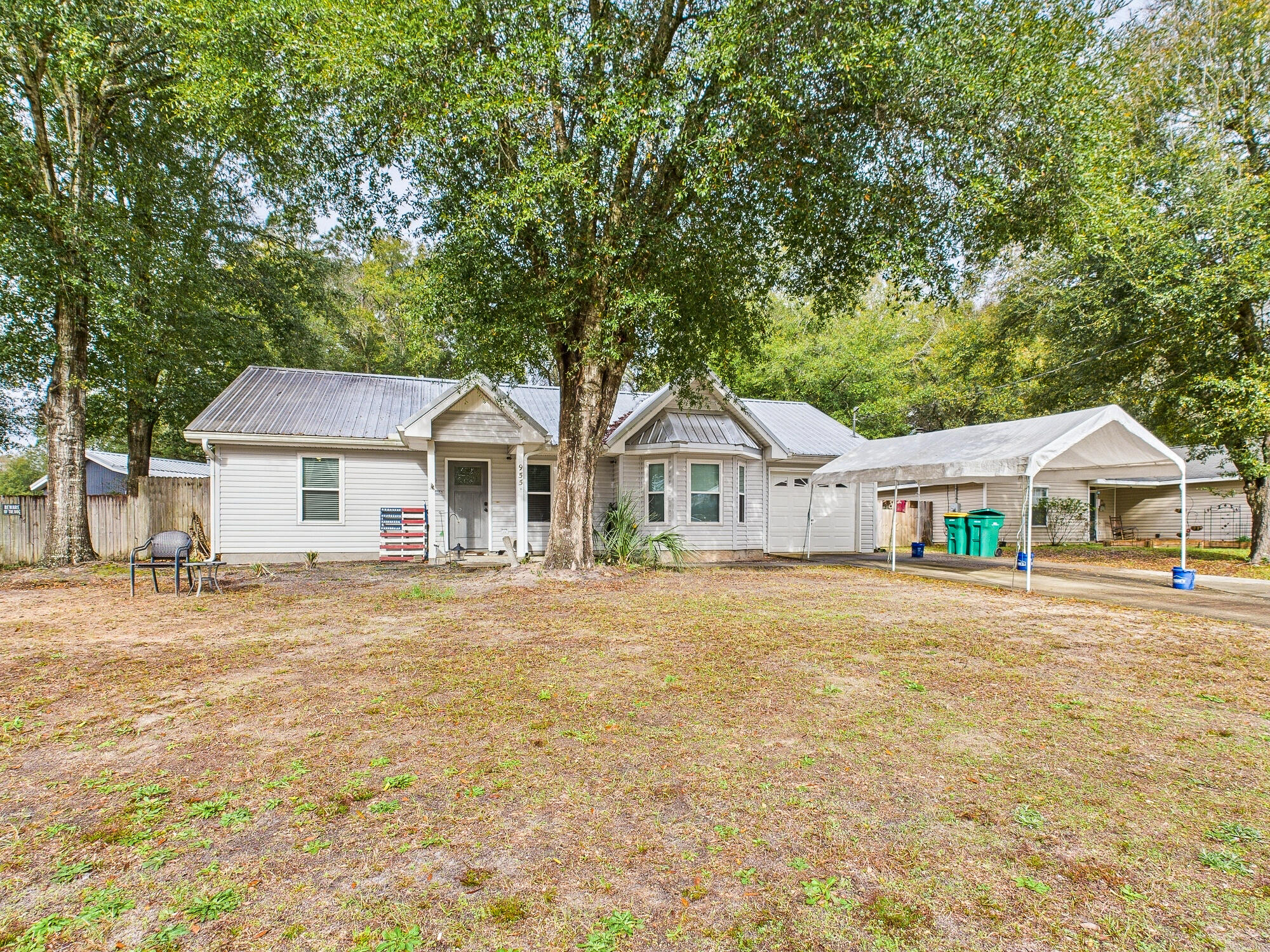 955 Valley Road Crestview, FL 32539 - Photo 2 of 29 a front view of a house with a garden