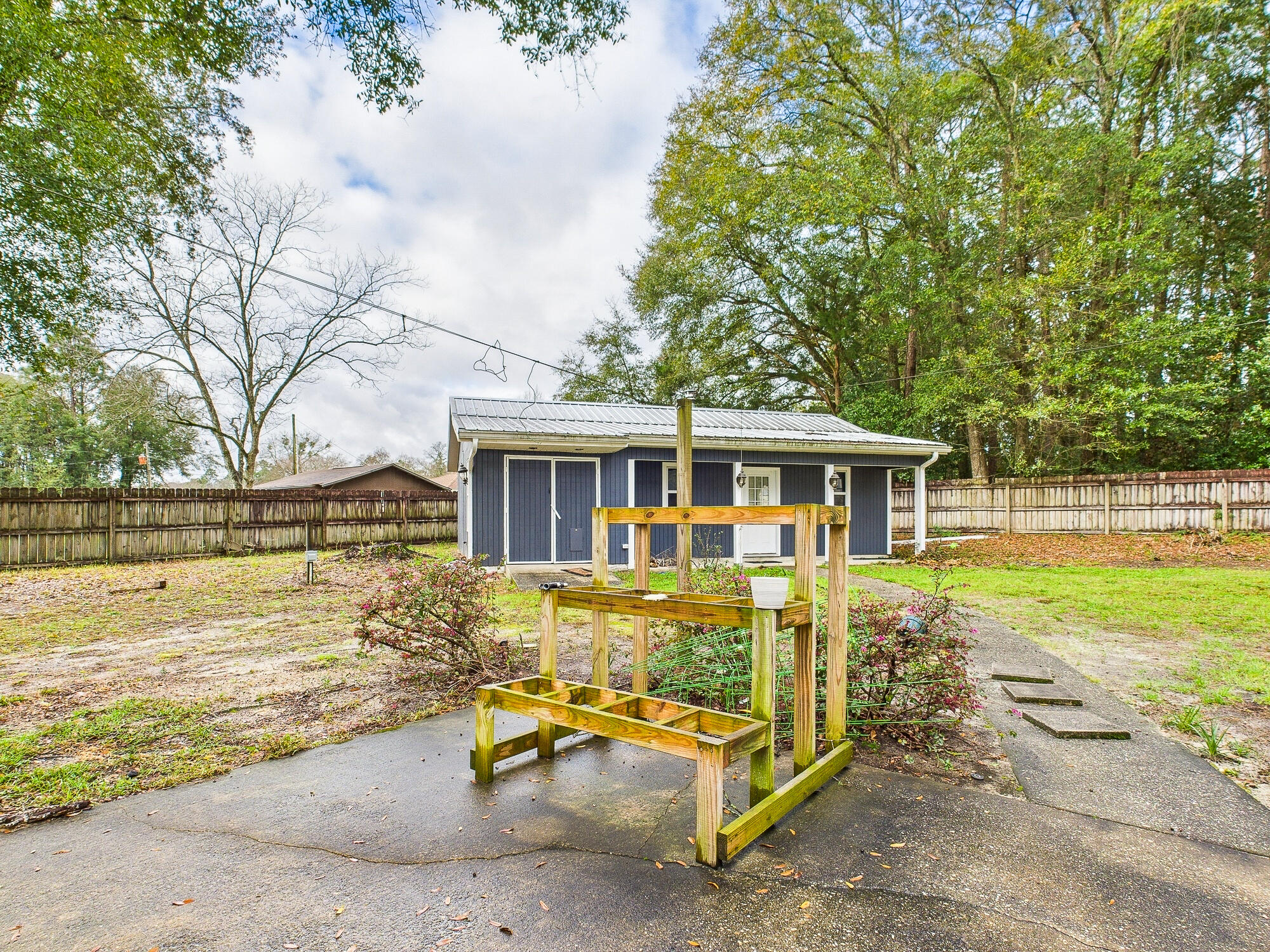 955 Valley Road Crestview, FL 32539 - Photo 23 of 29 a view of a house with pool and chairs next to a yard