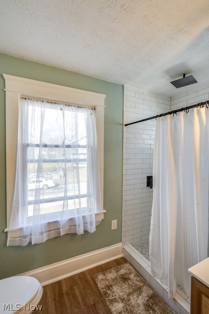 12 South 4th Street Rittman, OH 44270 - Photo 36 of 48 Bathroom featuring a stall shower, dark wood finished floors, and a textured ceiling