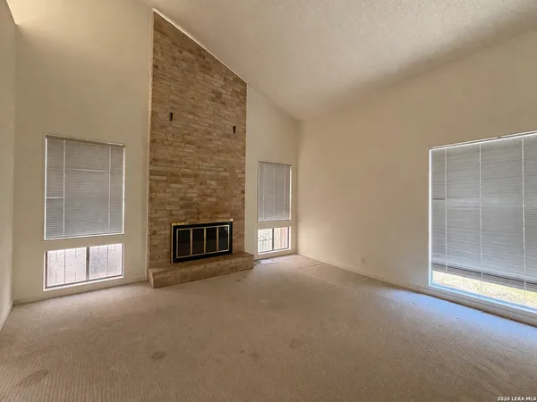 a view of empty room with a fireplace