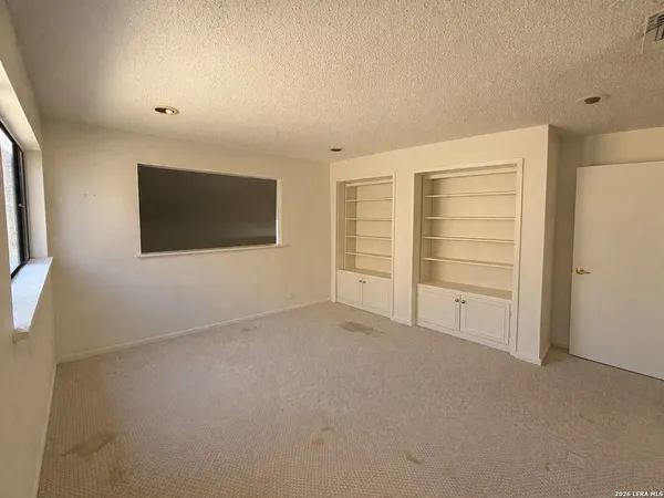 a view of an empty room with a fireplace