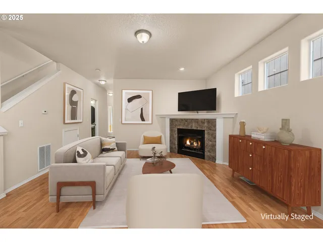 a living room with furniture a fireplace and a flat screen tv