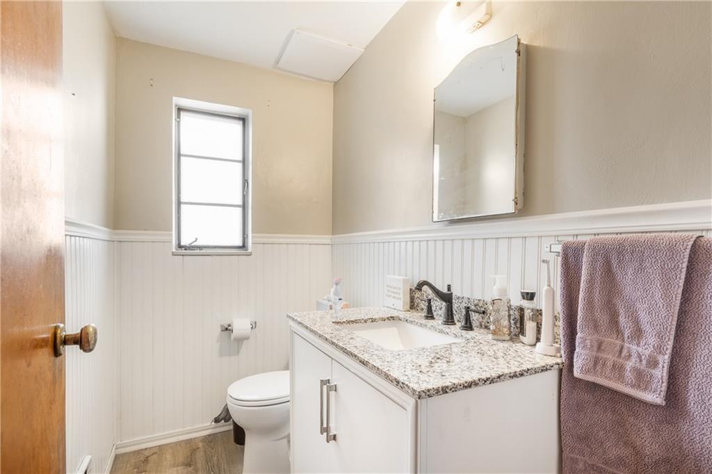 1308 Pine Hollow Road McKees Rocks, PA 15136 - Photo 20 of 25 a bathroom with a granite countertop sink toilet and a mirror