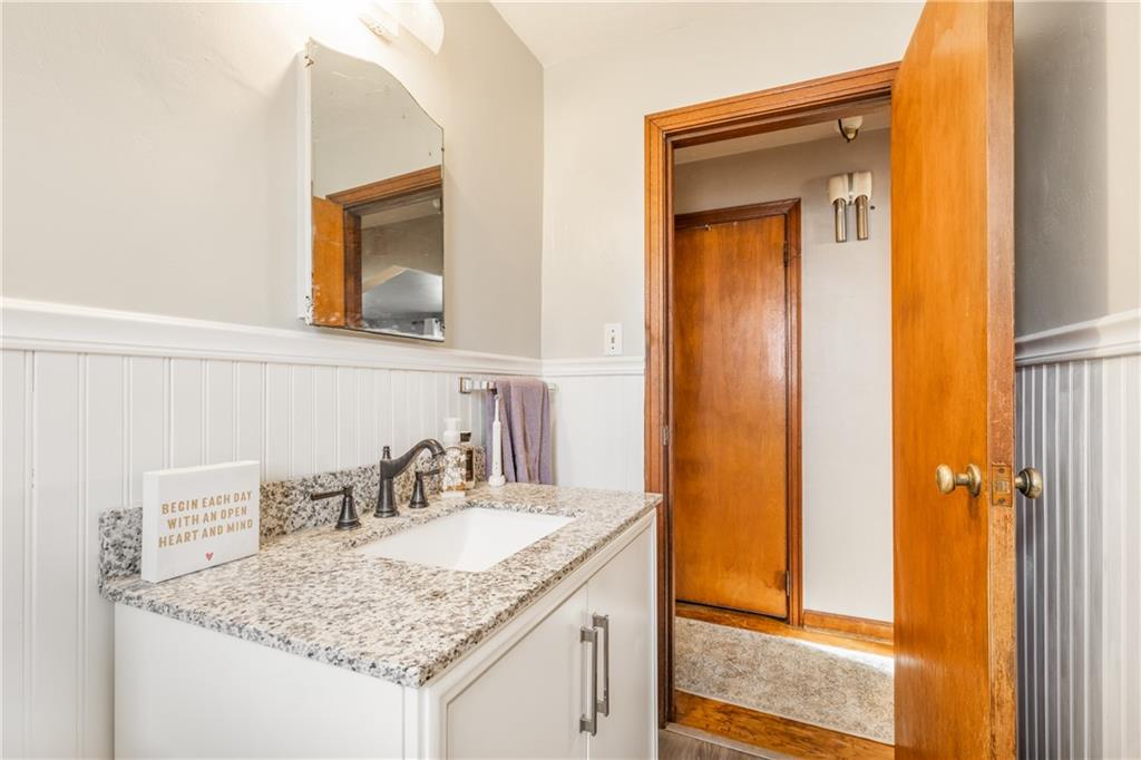 1308 Pine Hollow Road McKees Rocks, PA 15136 - Photo 21 of 25 a bathroom with a granite countertop sink and a mirror
