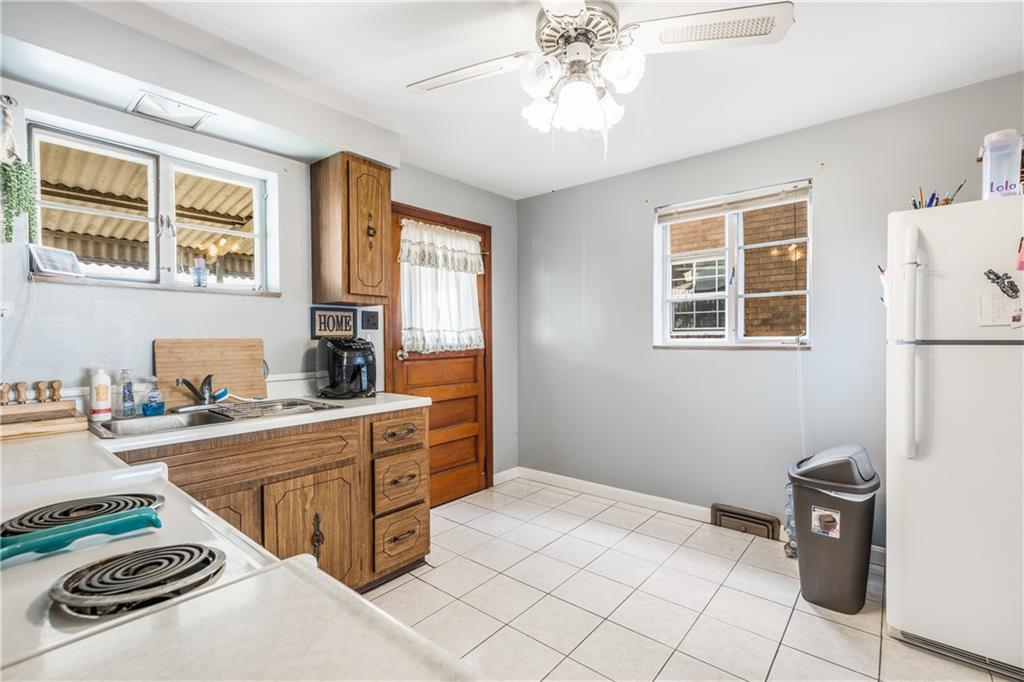 1308 Pine Hollow Road McKees Rocks, PA 15136 - Photo 6 of 25 a kitchen with stainless steel appliances kitchen island granite countertop a refrigerator and a stove top oven