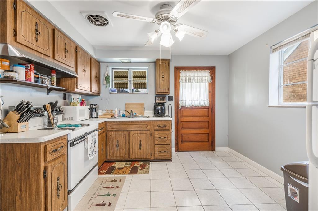 1308 Pine Hollow Road McKees Rocks, PA 15136 - Photo 7 of 25 a kitchen with stainless steel appliances granite countertop a sink and cabinets