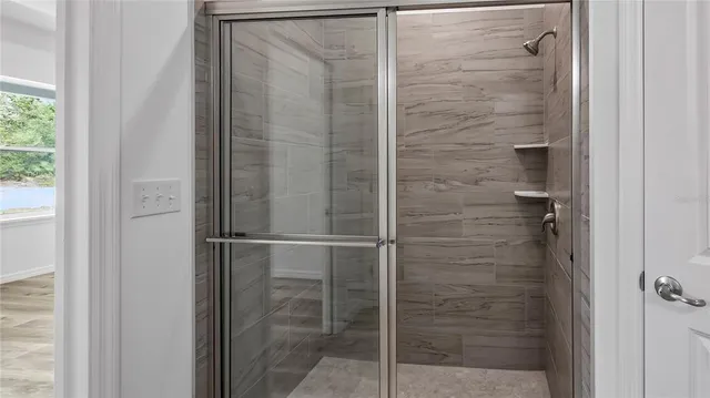 a bathroom with a glass shower door