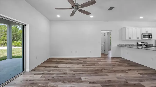 a view of a kitchen with a sink and a refrigerator