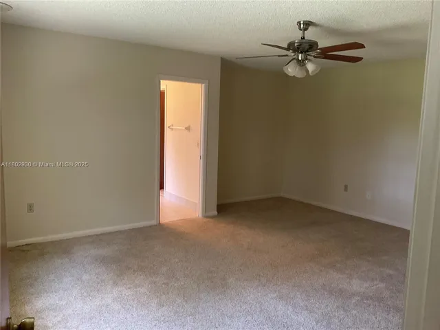 a view of a room with a fan and a window