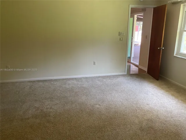 an empty room with a mirror