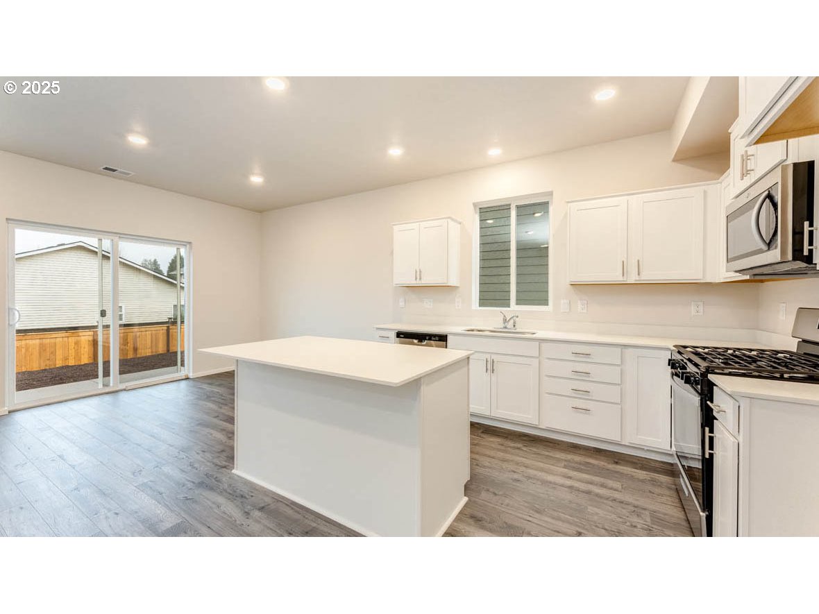 2811 U Street Springfield, OR 97477 - Photo 7 of 27 a kitchen with a sink and white cabinets