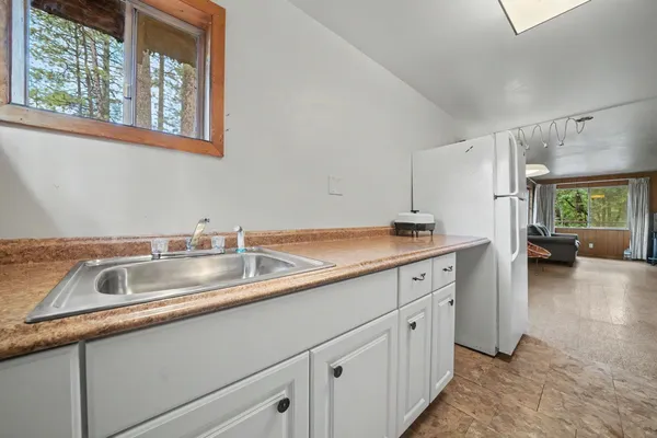 a kitchen with sink and cabinets