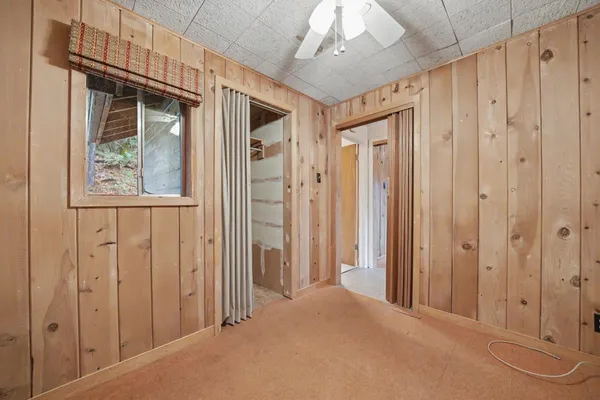 a view of a room with a wooden door