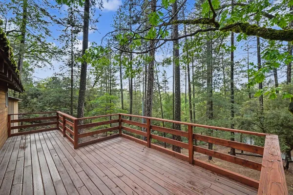 a balcony with wooden floor and outdoor space